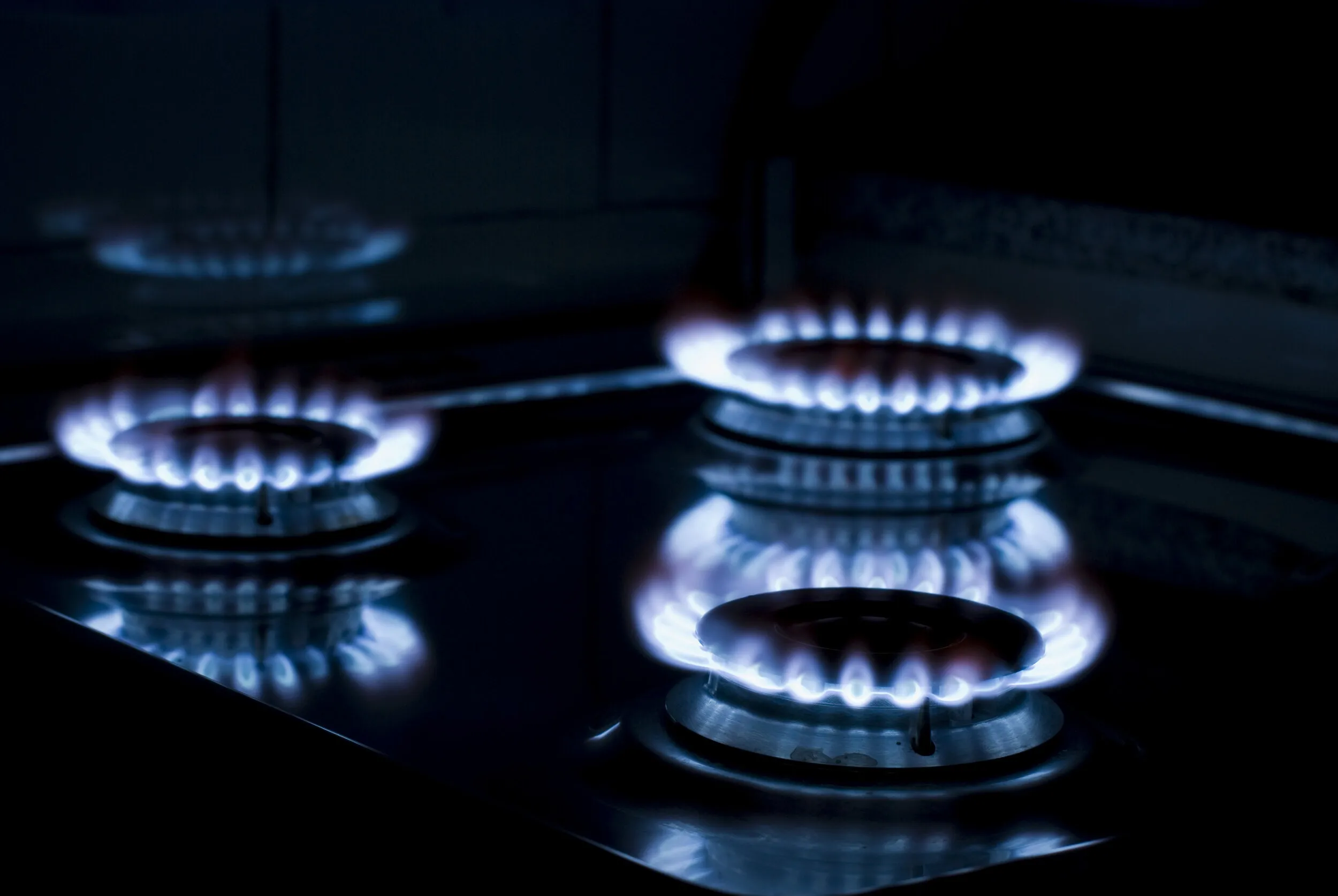 Gas hob burning on a kitchen bench