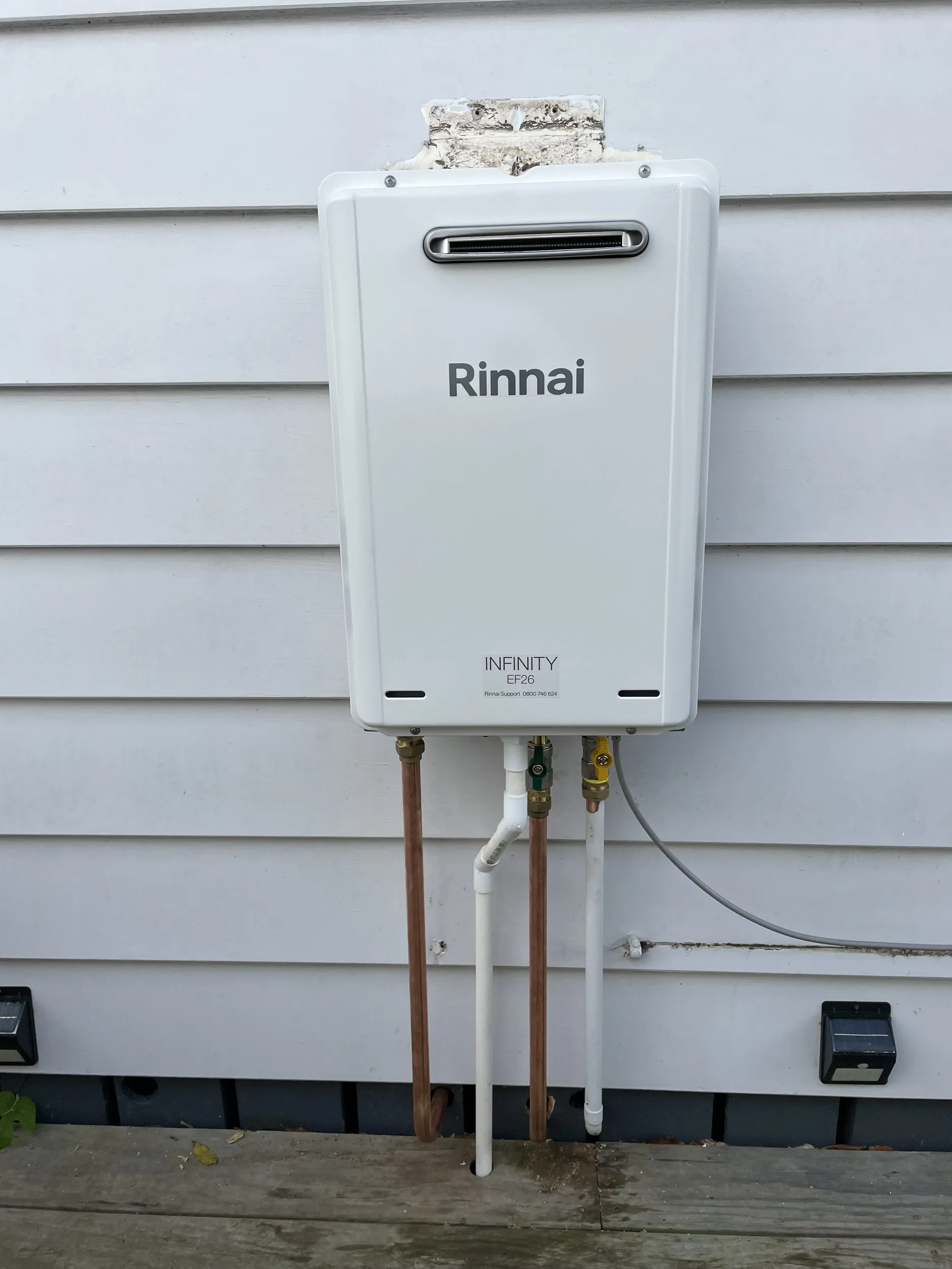 Rinnai continuous flow gas hot water unit on an exterior wall